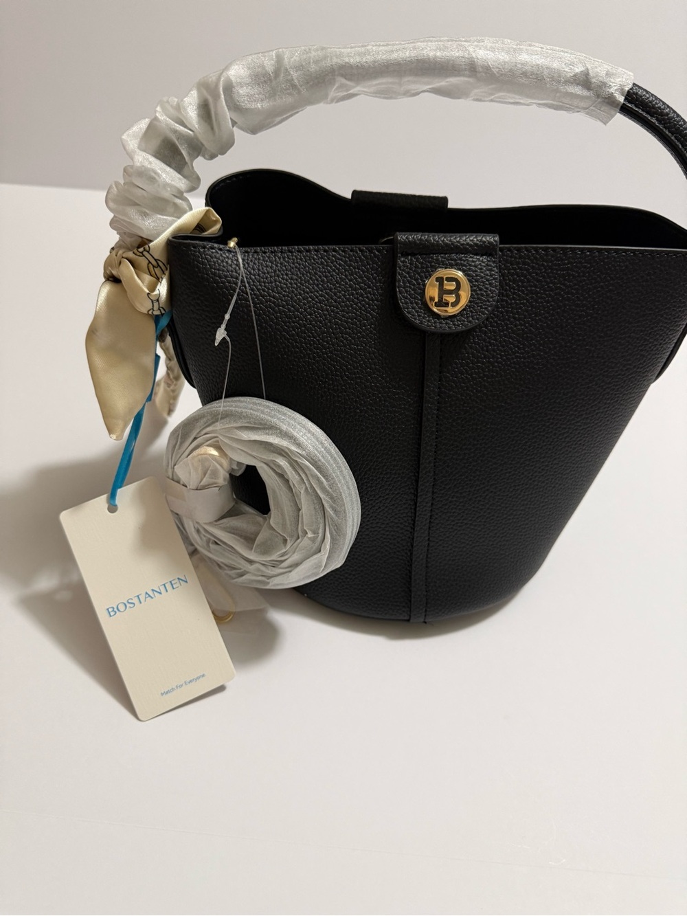 Black Pebbled Bucket Handbag with Gold Emblem